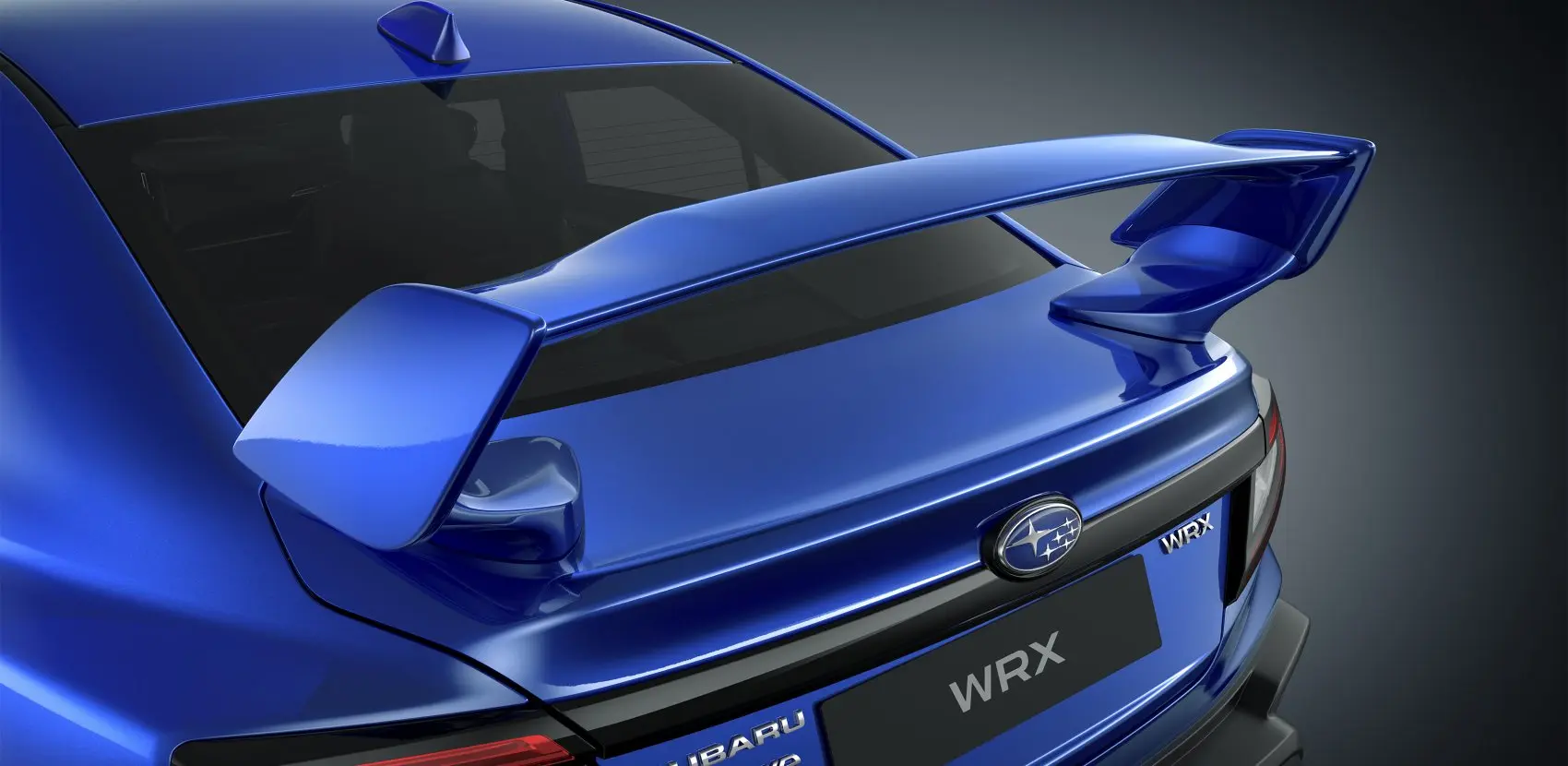 Parte trasera de auto deportivo WRX en color azul sobre fondo negro. 